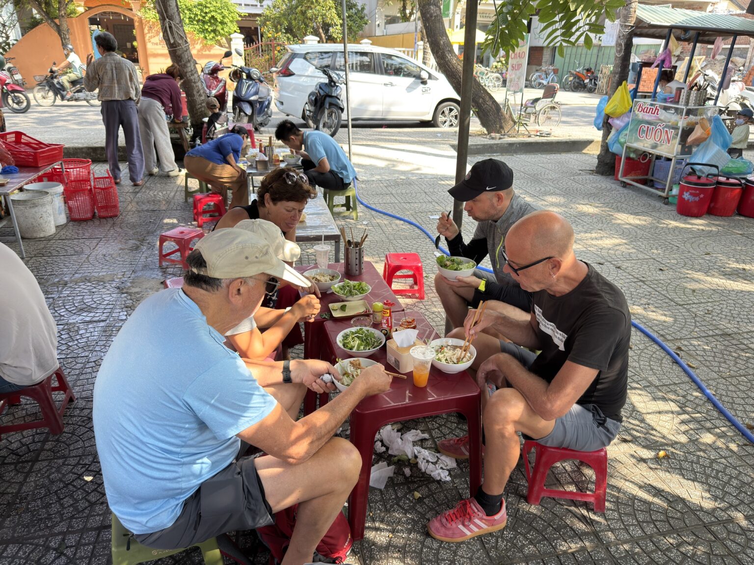 conversation over a shared meal at a street food table